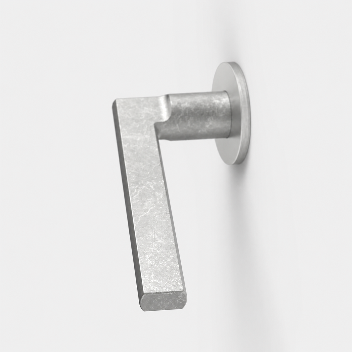 FSB 1035 matte silver architectural door lever with a flat, ergonomic design on a circular rose against a white wall.