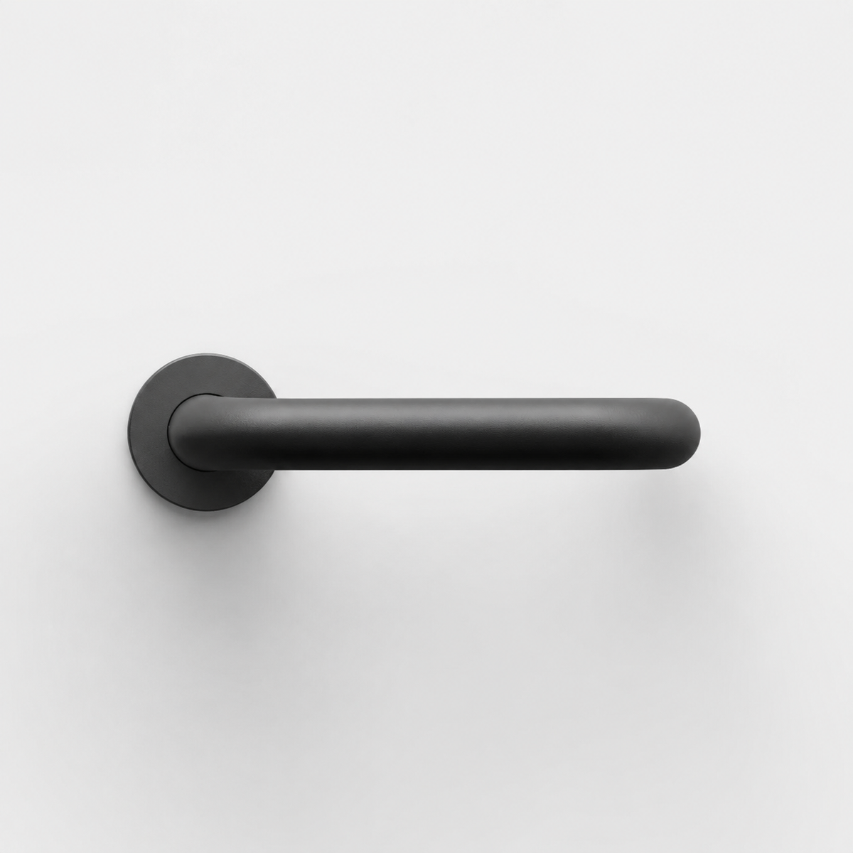 Matte black FSB 1070 U-shaped door lever with a circular rose on a clean white background.