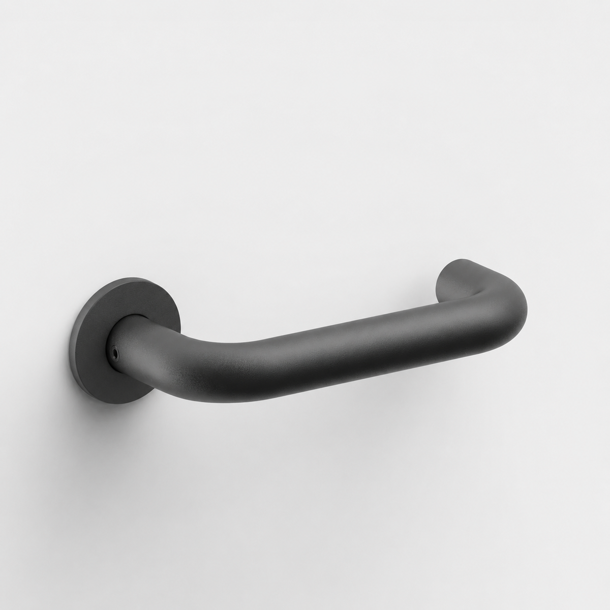 Matte black FSB 1070 U-shaped door lever with a closed return on a circular rose against a white background.