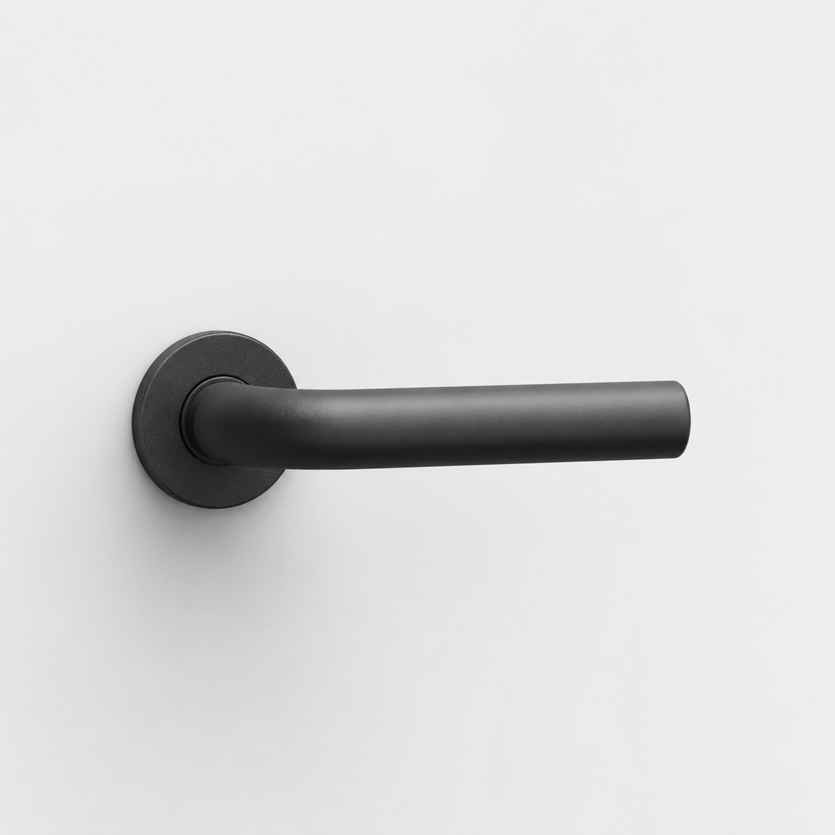 Matte black FSB 1075 L-shaped door lever with a circular rose, mounted on a plain white background.