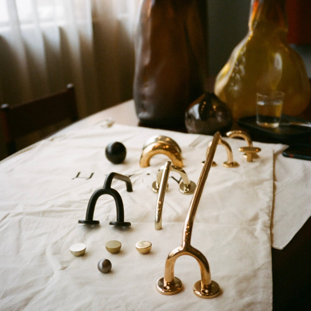 Brass Maha Alavi Fauna hardware on a table.