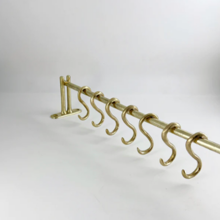 A Mi & Gei Forme No. 1 Hanging Rail with five hooks on it.