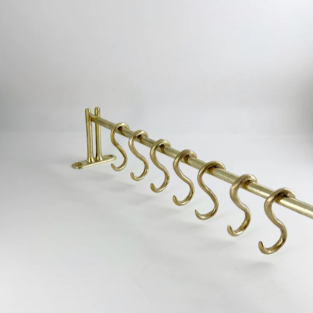 A Mi & Gei Forme No. 1 Hanging Rail with five hooks on it.