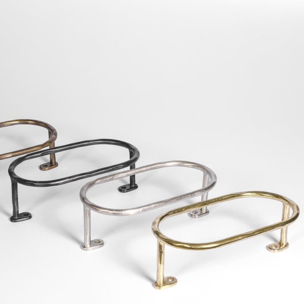 Four Mi & Gei Forme No. 11 Oval Towel Bar on a white background in all finishes