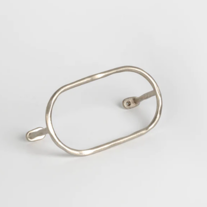a Mi & Gei silver ring with a hole in the middle.