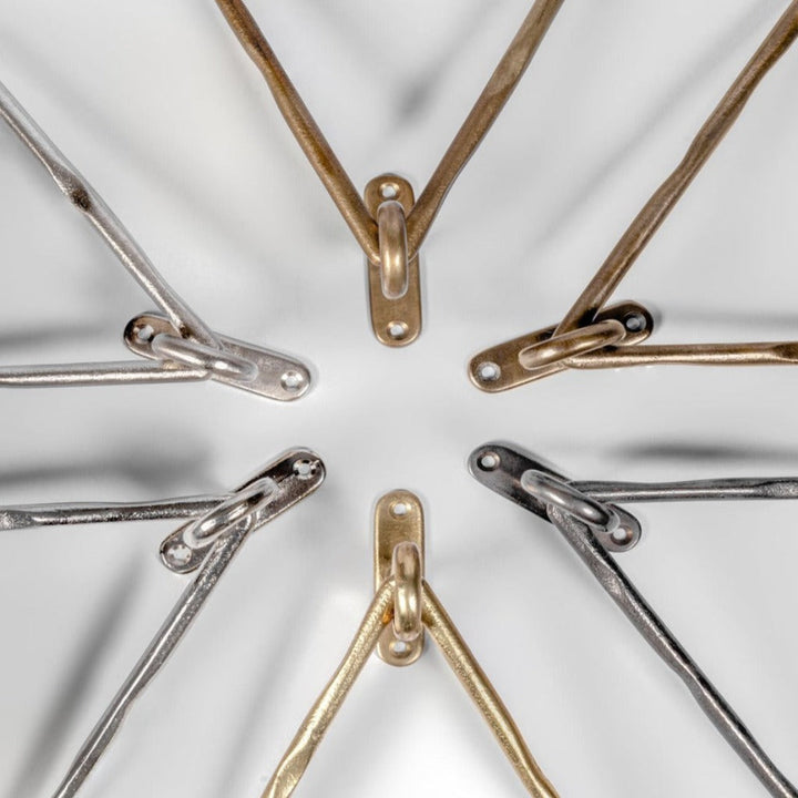 Mi & Gei Forme No. 14 Triangle Towel Rings in a circle on a white surface.