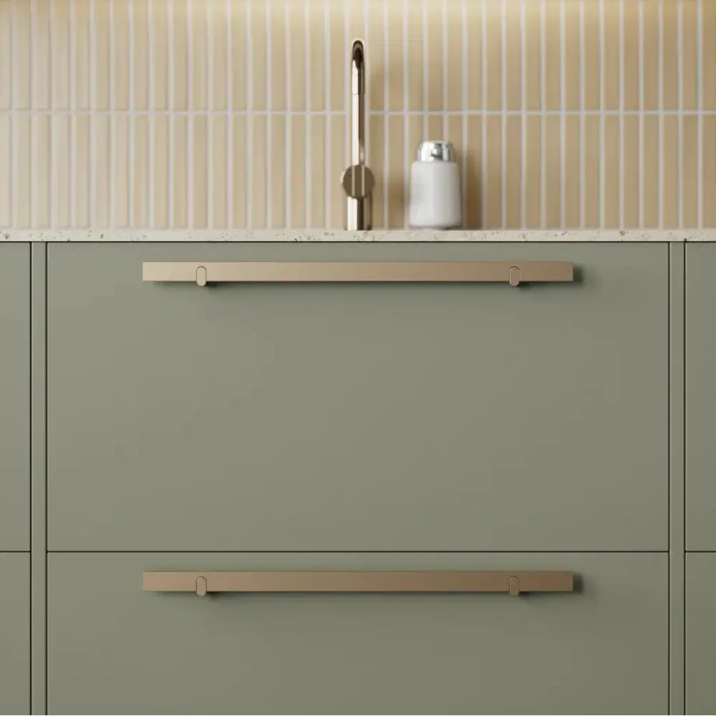 Metal cabinet pull mounted on green drawer