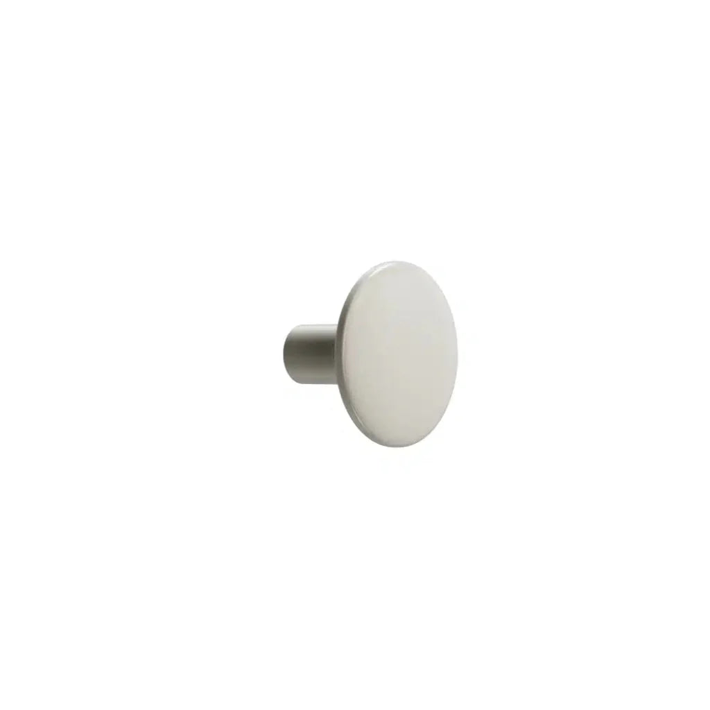 White circular cabinet knob on white background