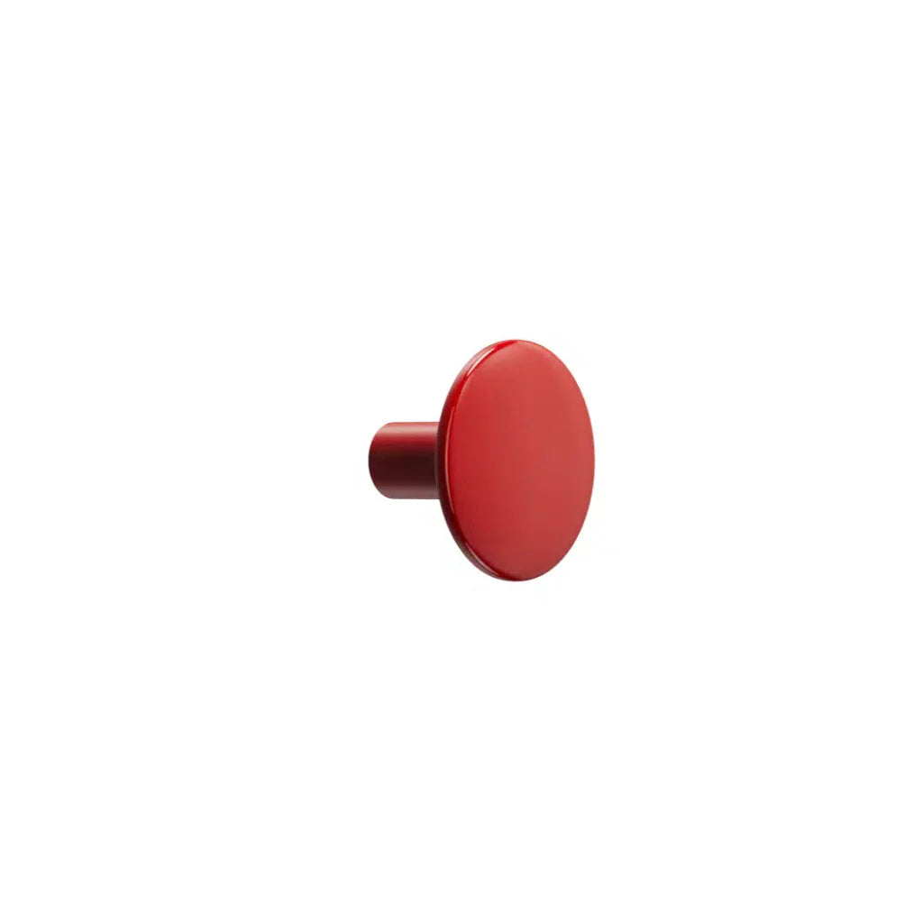 Red circular cabinet knob on white background