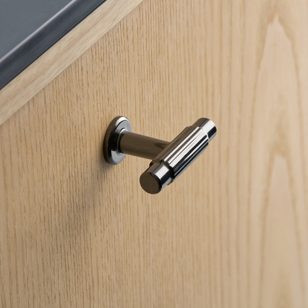 Satin nickel Furnipart Villa T cabinet knob on a grey drawer.