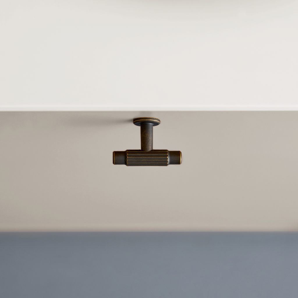 Satin nickel Furnipart Villa T cabinet knob on a grey drawer.