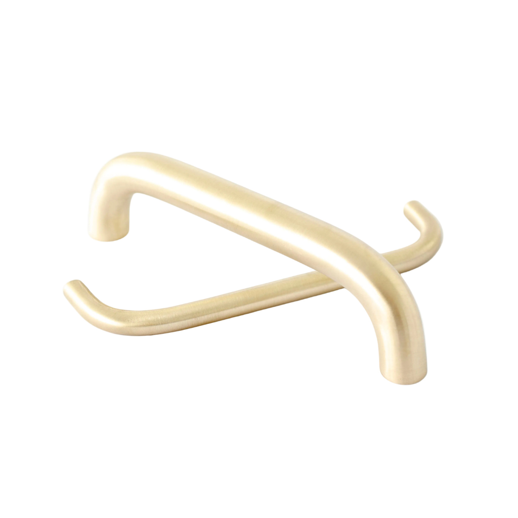 Two satin brass slim Grip cabinet pulls overlapping on white, thin rounded bars.