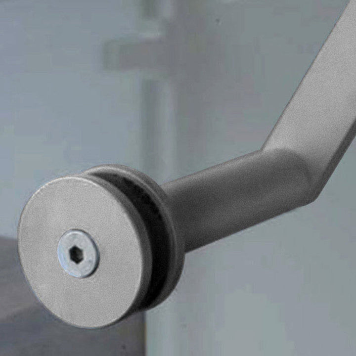 A close up of a Halliday Baillie handle on a door, fixed with the HB 512 Glass Fixing Kit.