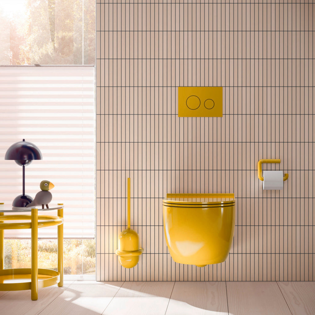 A tiled bathroom with a yellow toilet and Hewi 477 fittings.