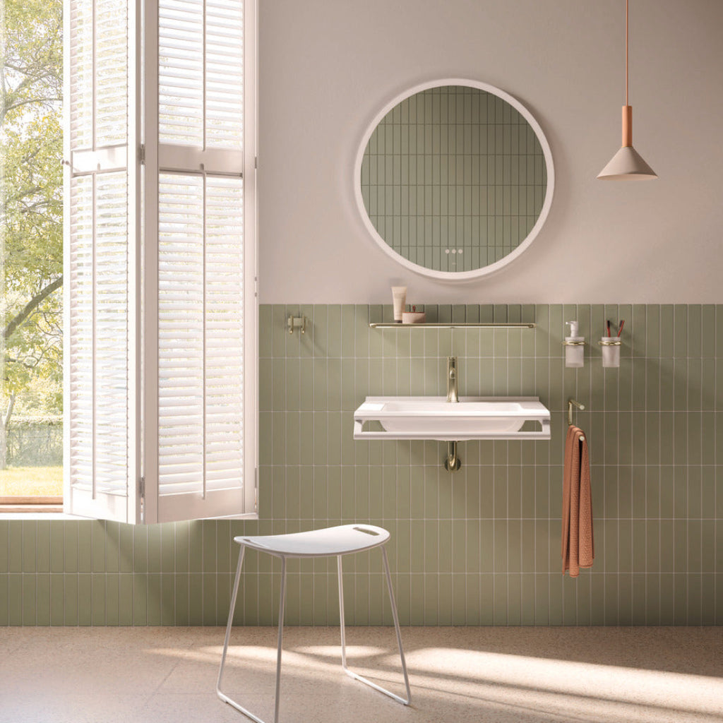 A green-walled bathroom with a Hewi 480 shelf and mirror.
