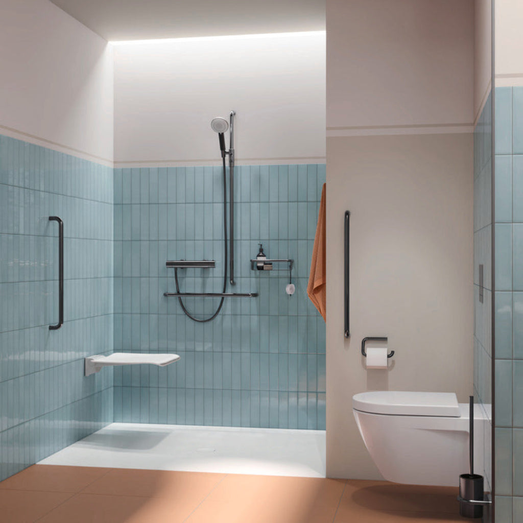 A blue-walled bathroom with Hewi 480 grab bars and shower fittings.