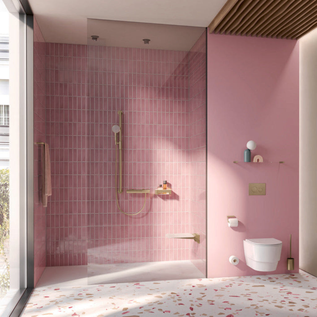 A pink-tiled bathroom with Hewi 900 shower fittings.