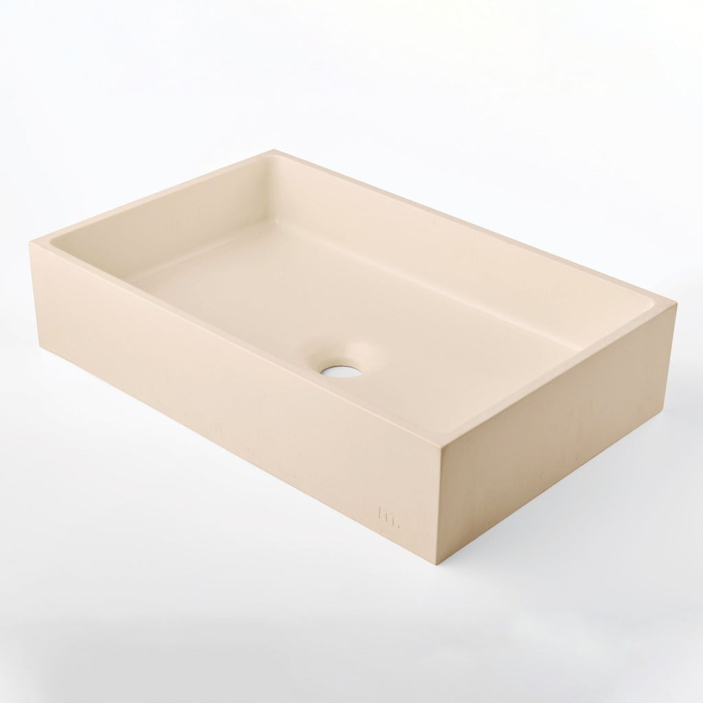 A mudd. concrete Jeker Basin sink sitting on top of a mudd. concrete white counter.