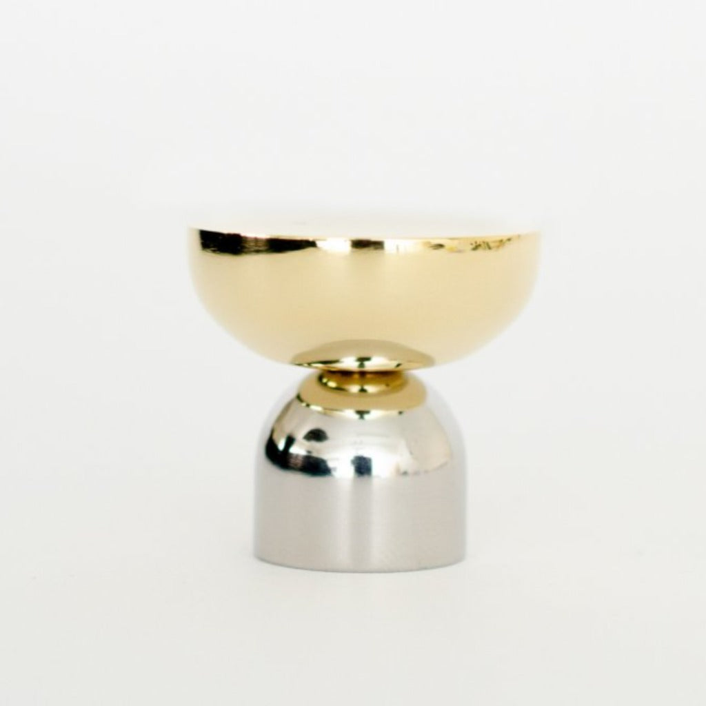 A Kokeshi Mix Knob / Hook by Baccman Berglund sitting on top of a white table.