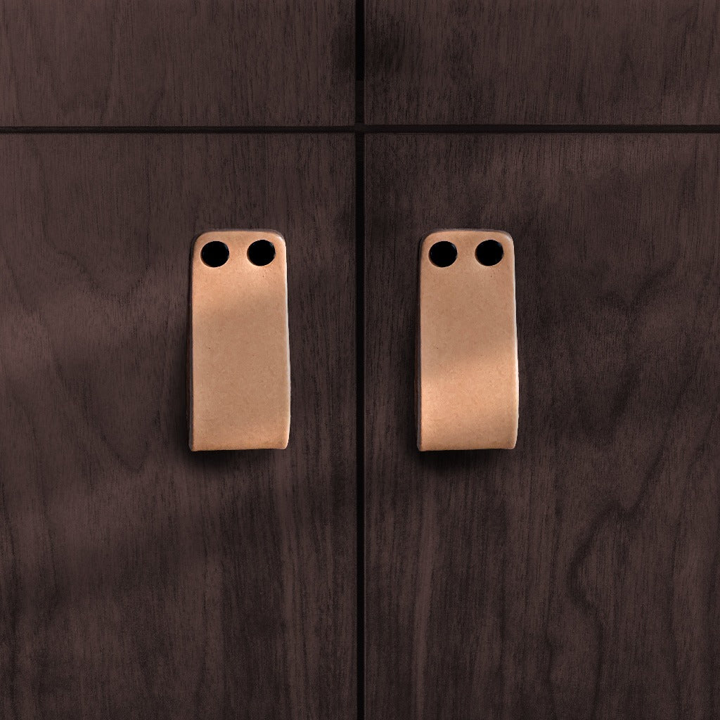 natural vegetable tanned leather loop cabinet pull with 2 black capped fasteners mounted on walnut wood cabinets from Chapman and Bose