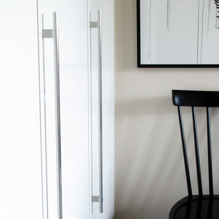 A black Line Big Handle chair sitting in front of a white Baccman Berglund refrigerator.