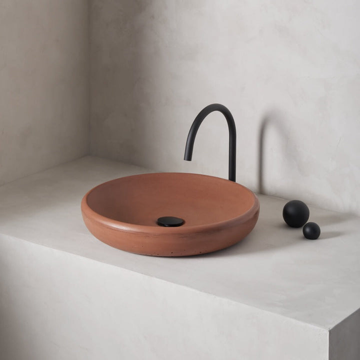 A large, circular washbowl with a gradual shallow slope and low-profile, round-over basin walls