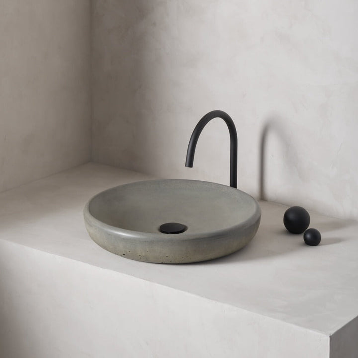 A large, circular washbowl with a gradual shallow slope and low-profile, round-over basin walls
