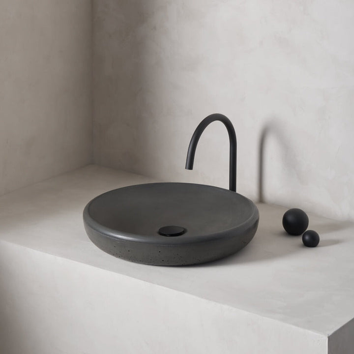 A large, circular washbowl with a gradual shallow slope and low-profile, round-over basin walls