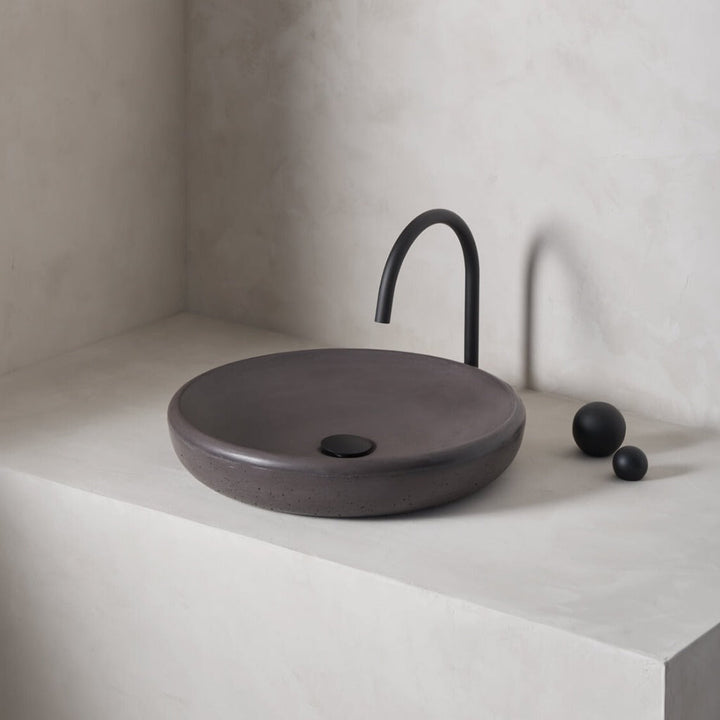 A large, circular washbowl with a gradual shallow slope and low-profile, round-over basin walls