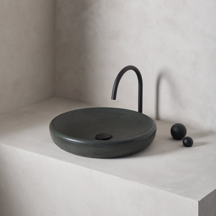 A large, circular washbowl with a gradual shallow slope and low-profile, round-over basin walls