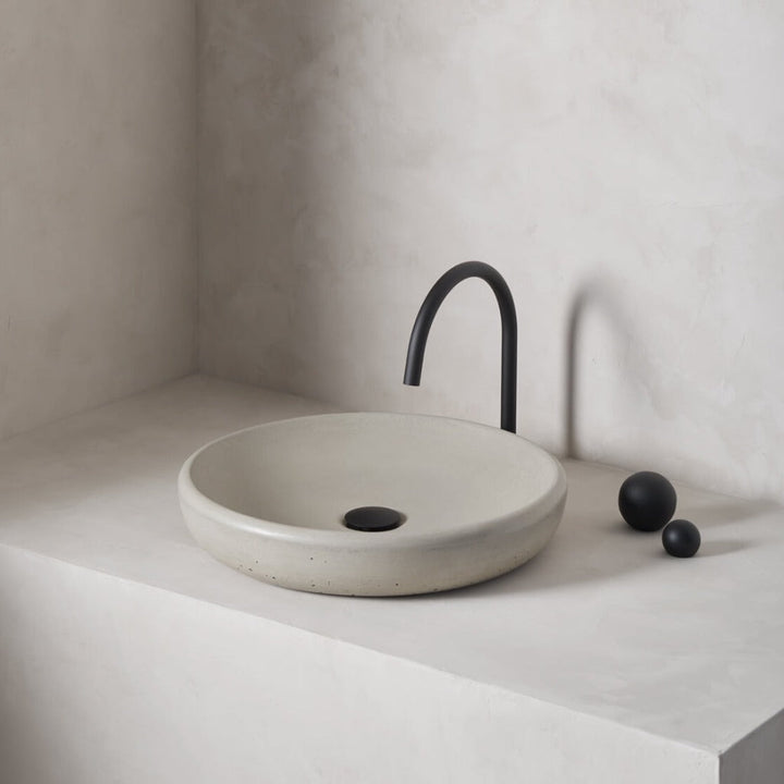 A large, circular washbowl with a gradual shallow slope and low-profile, round-over basin walls