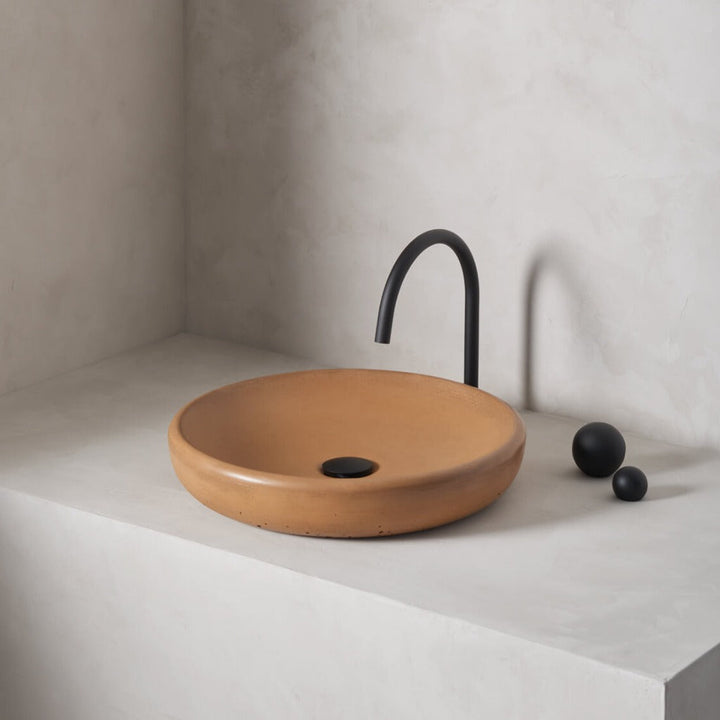 A large, circular washbowl with a gradual shallow slope and low-profile, round-over basin walls