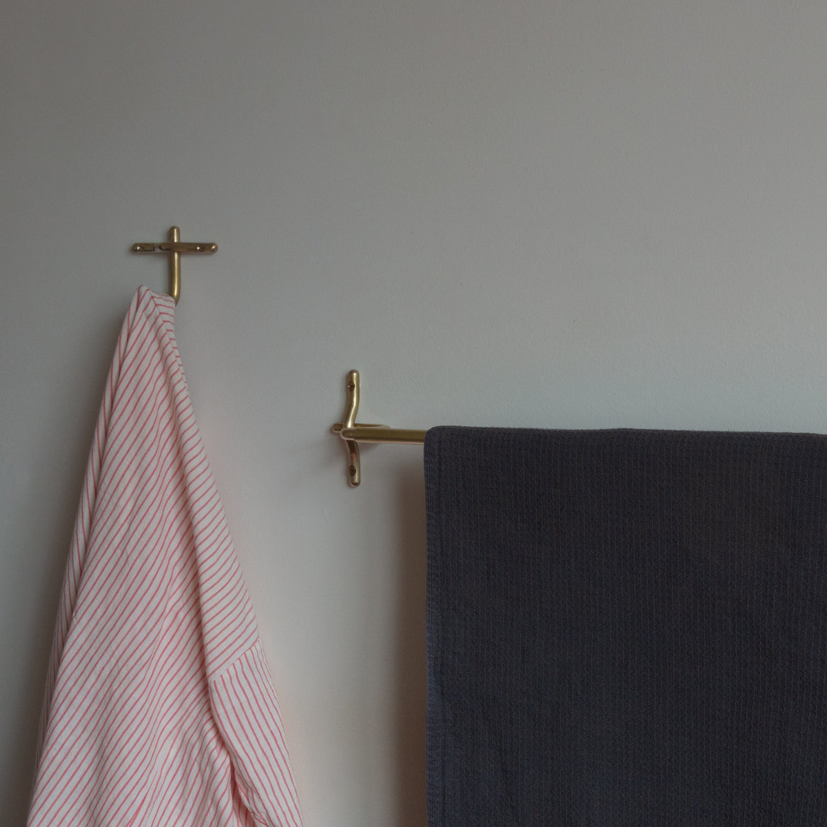 Brass ALL BETTER WORKSHOP Luma hand towel bar with a towel.
