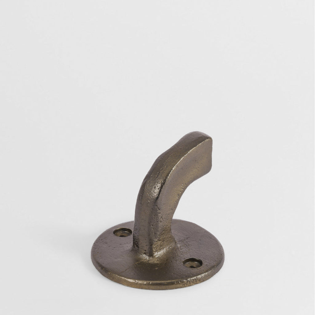 Hand-cast bronze wall hook with a curved, sculptural design and a textured, matte finish on a white background.