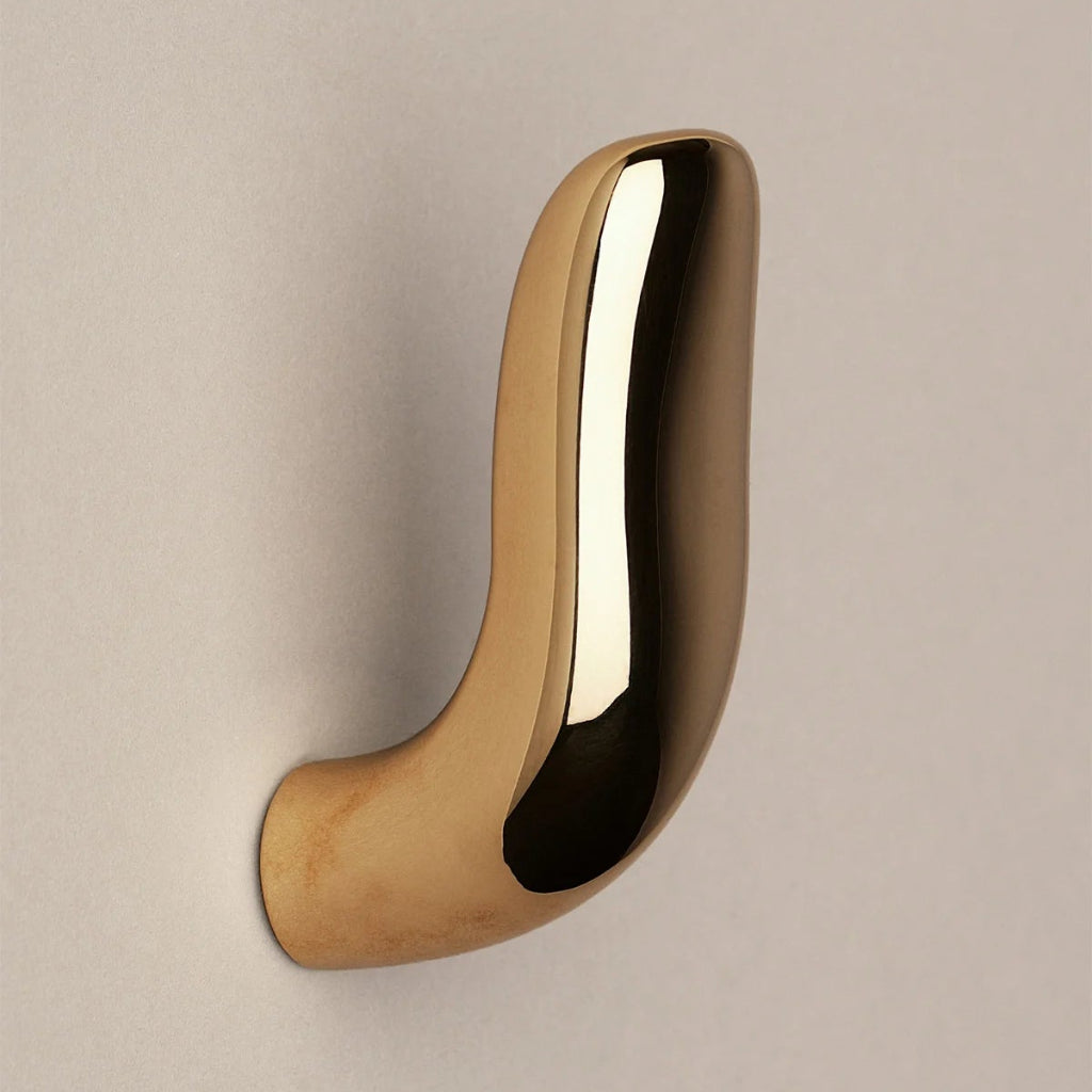 Softly curved J shaped hook in polished brass, side view.