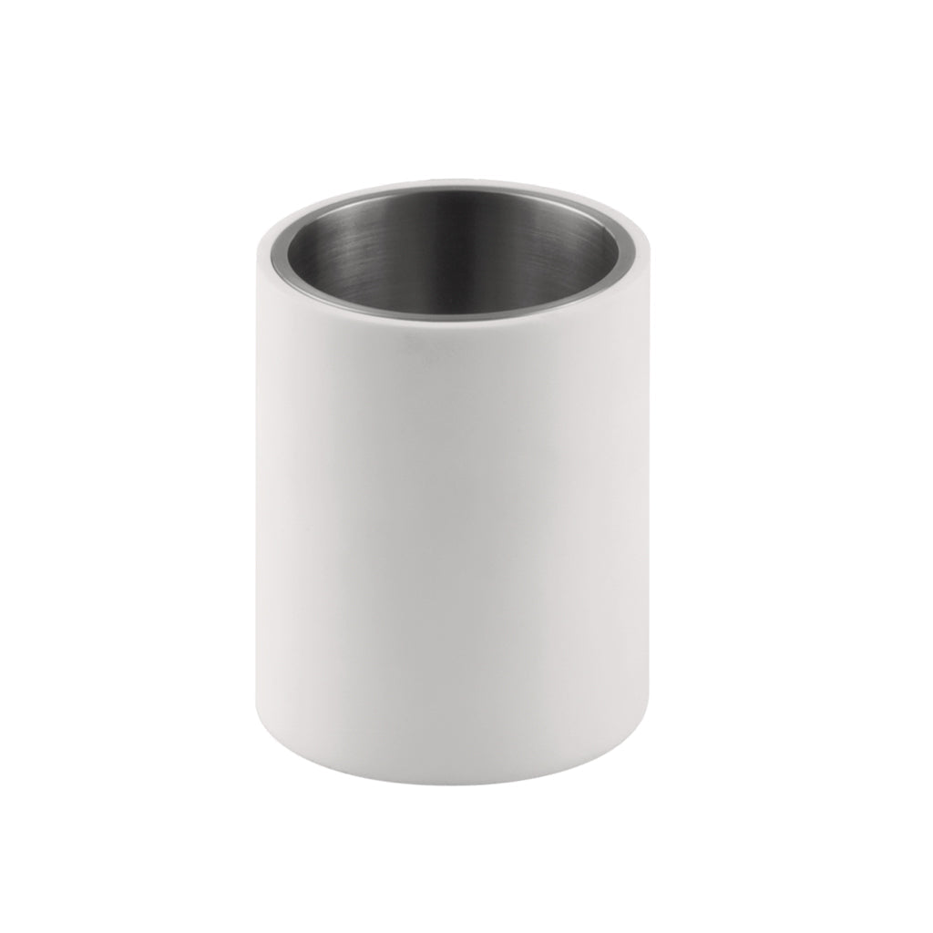 A toothbrush container made of white corian exterior and stainless interior