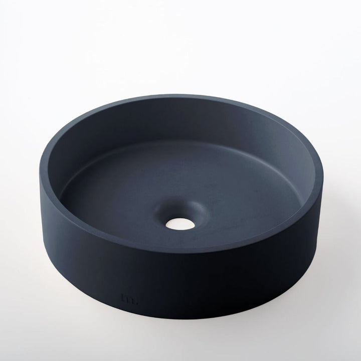 A mudd. concrete Odet Basin LG sink on a white surface.
