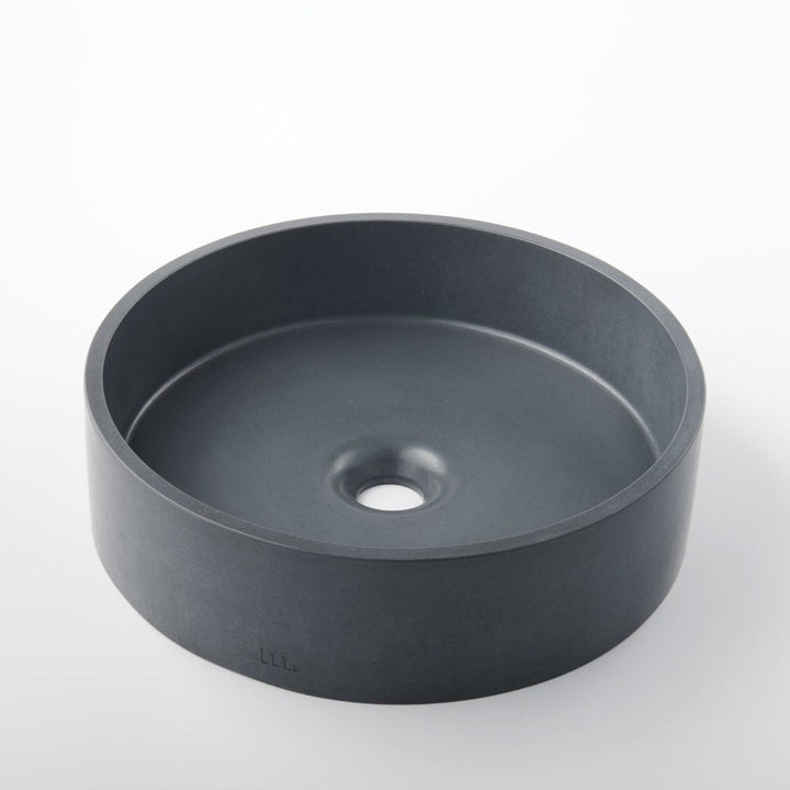 A mudd. concrete Odet Basin LG sitting on top of a white table.