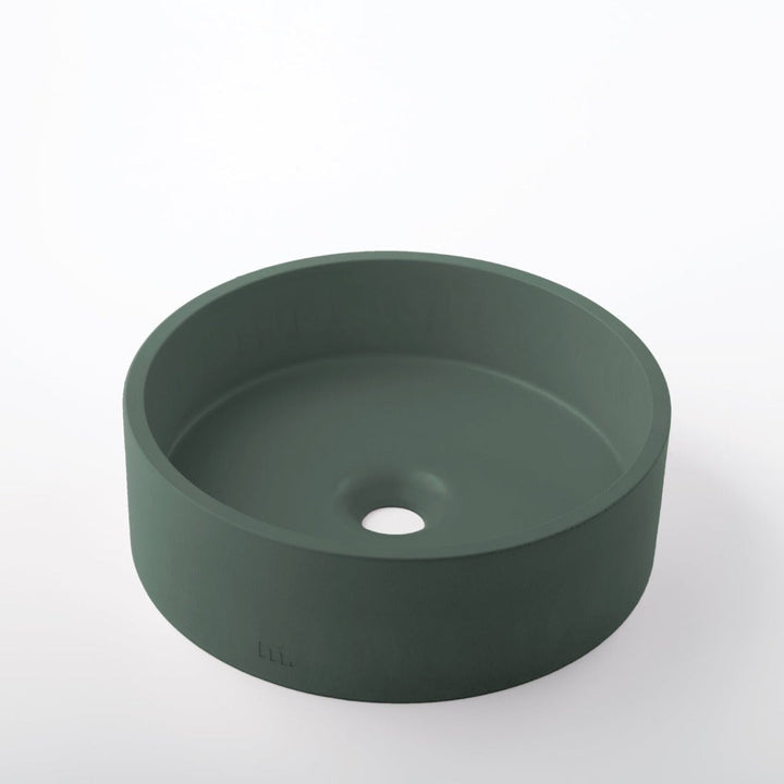 A round green Odet Basin SM from mudd. concrete with a hole in the middle.