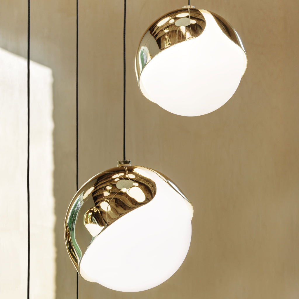 Brass and white Anony Ohm chandelier globe, a half-brass half-glass sphere.