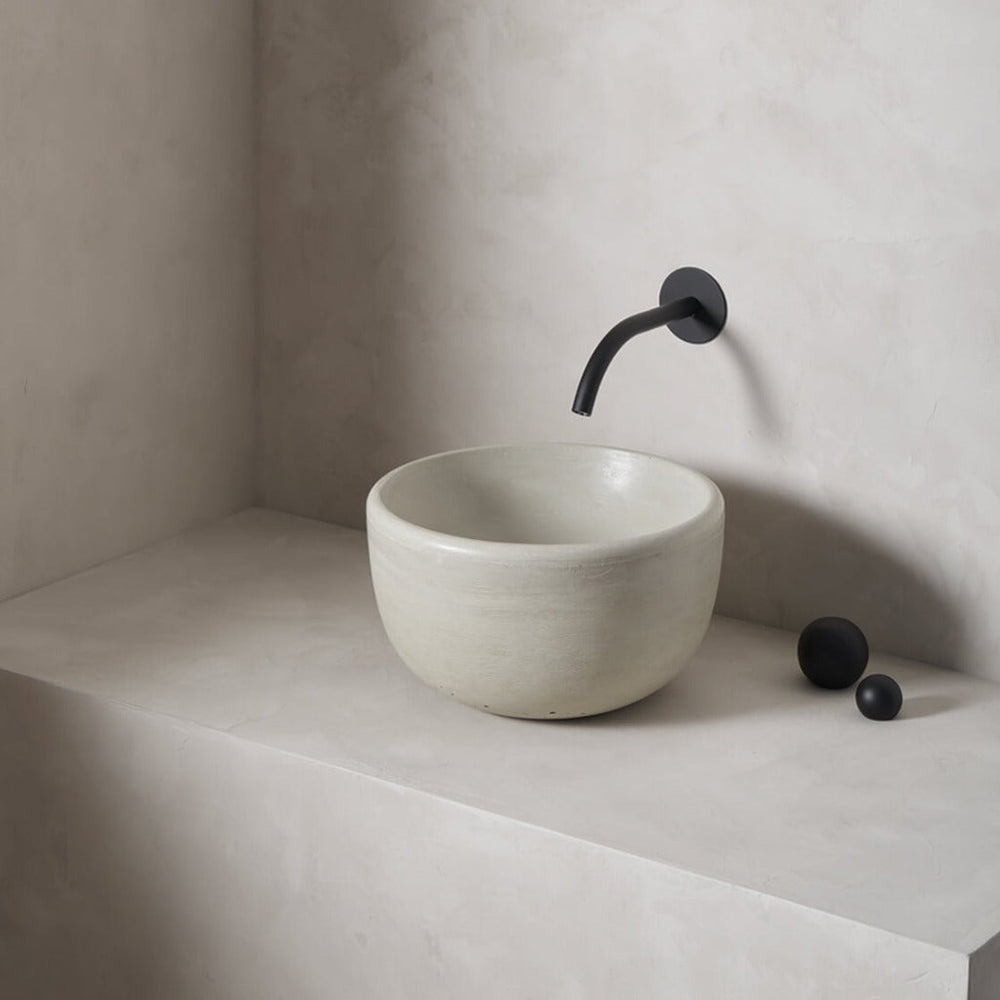 A petite and tall circular washbowl with an uplifted sink interior and round-over basin walls