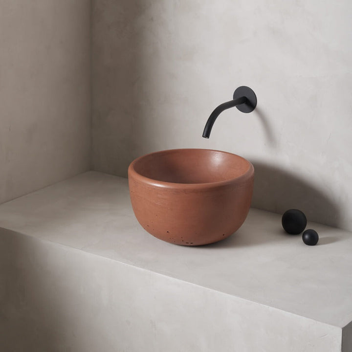 A petite and tall circular washbowl with an uplifted sink interior and round-over basin walls