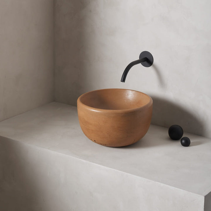 A petite and tall circular washbowl with an uplifted sink interior and round-over basin walls