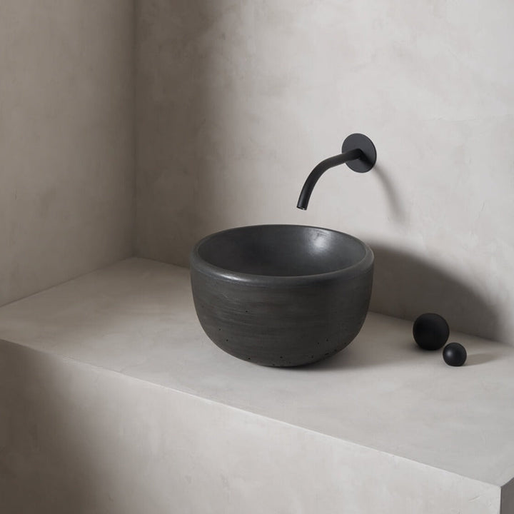 A petite and tall circular washbowl with an uplifted sink interior and round-over basin walls