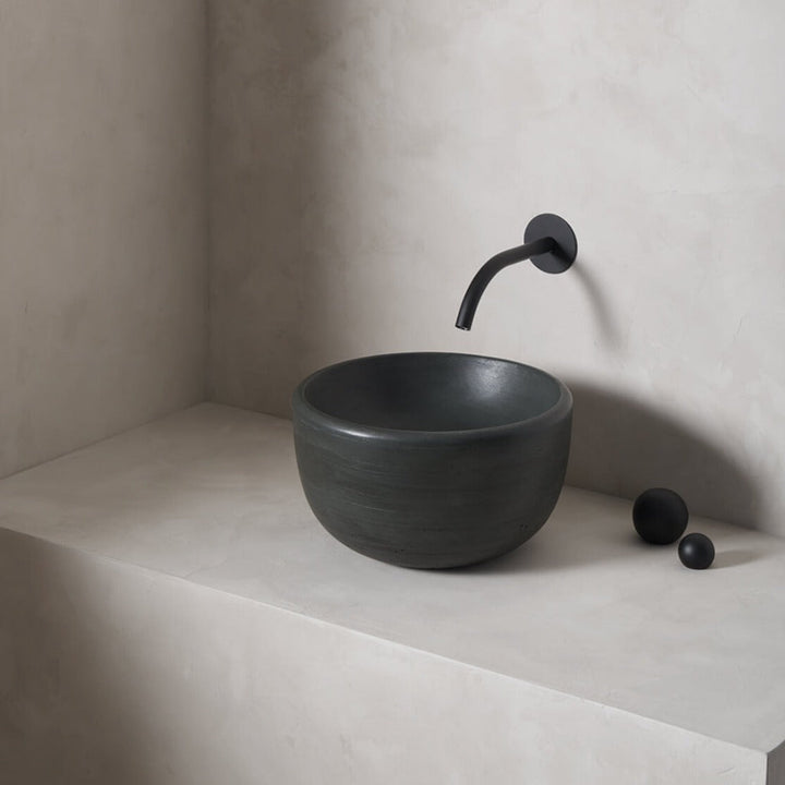 A petite and tall circular washbowl with an uplifted sink interior and round-over basin walls