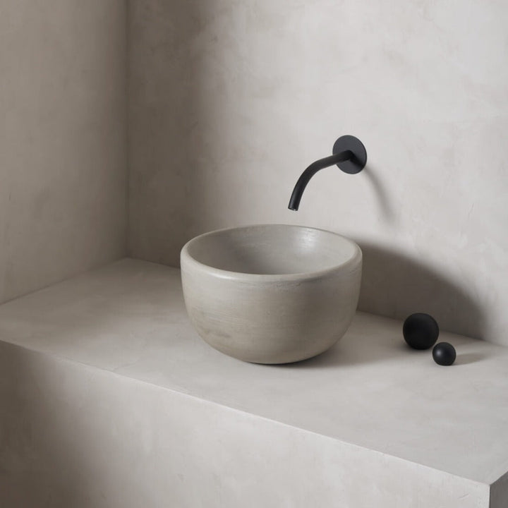 A petite and tall circular washbowl with an uplifted sink interior and round-over basin walls