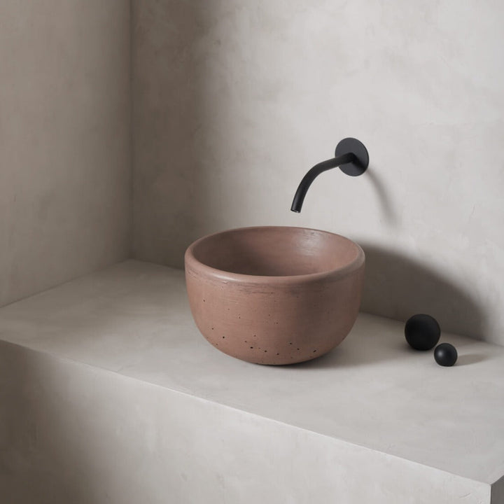 A petite and tall circular washbowl with an uplifted sink interior and round-over basin walls