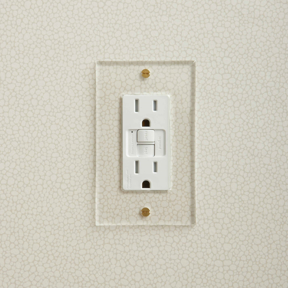 White Forbes & Lomax invisible plate with a GFCI outlet.