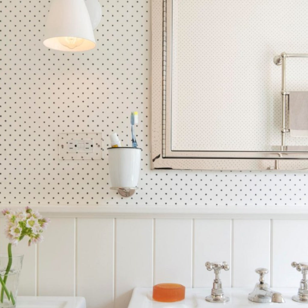 A bathroom with a Forbes & Lomax outlet.