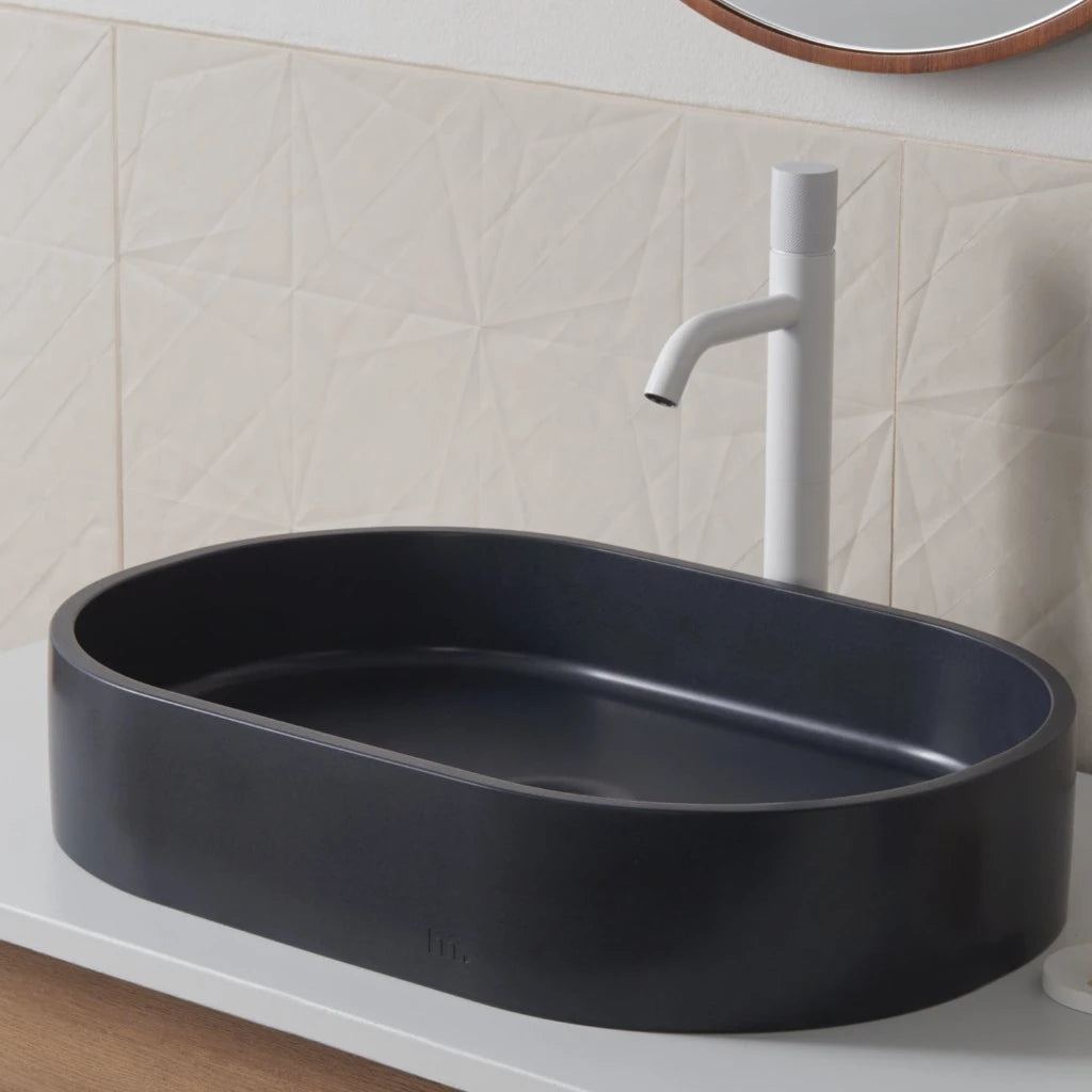 A Parro Basin LG from mudd. concrete sitting on top of a counter.